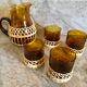 Pitcher and amber glasses and rattan