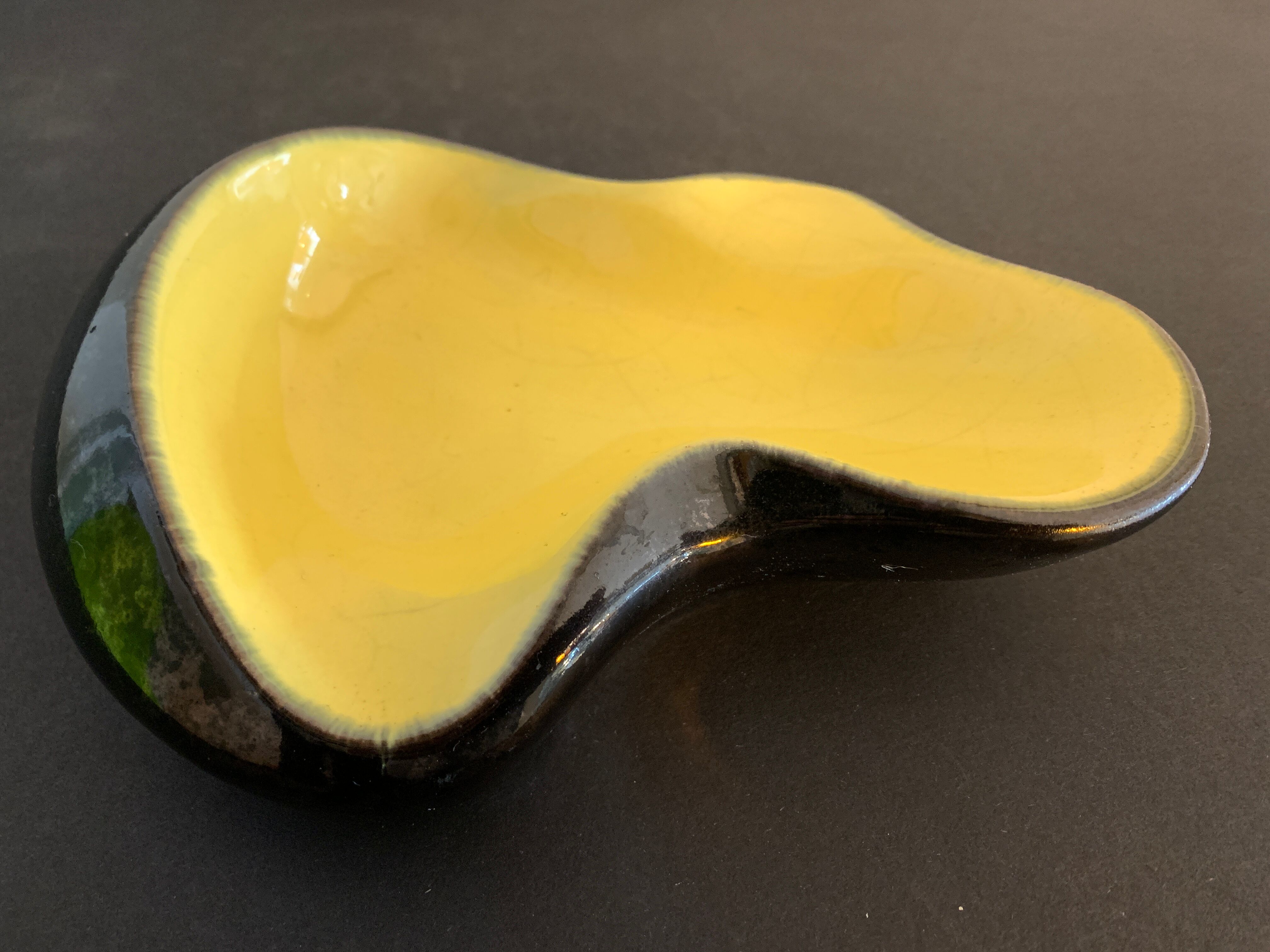 Yellow and black ceramic ashtray