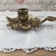 Hand-held candle holder called "cellar rat" in brass with vine leaf decoration