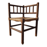 Vintage chair by the fireplace made of turned wood spool.