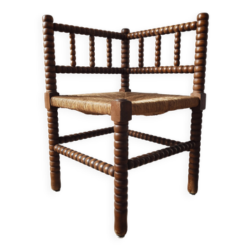 Vintage chair by the fireplace made of turned wood spool.