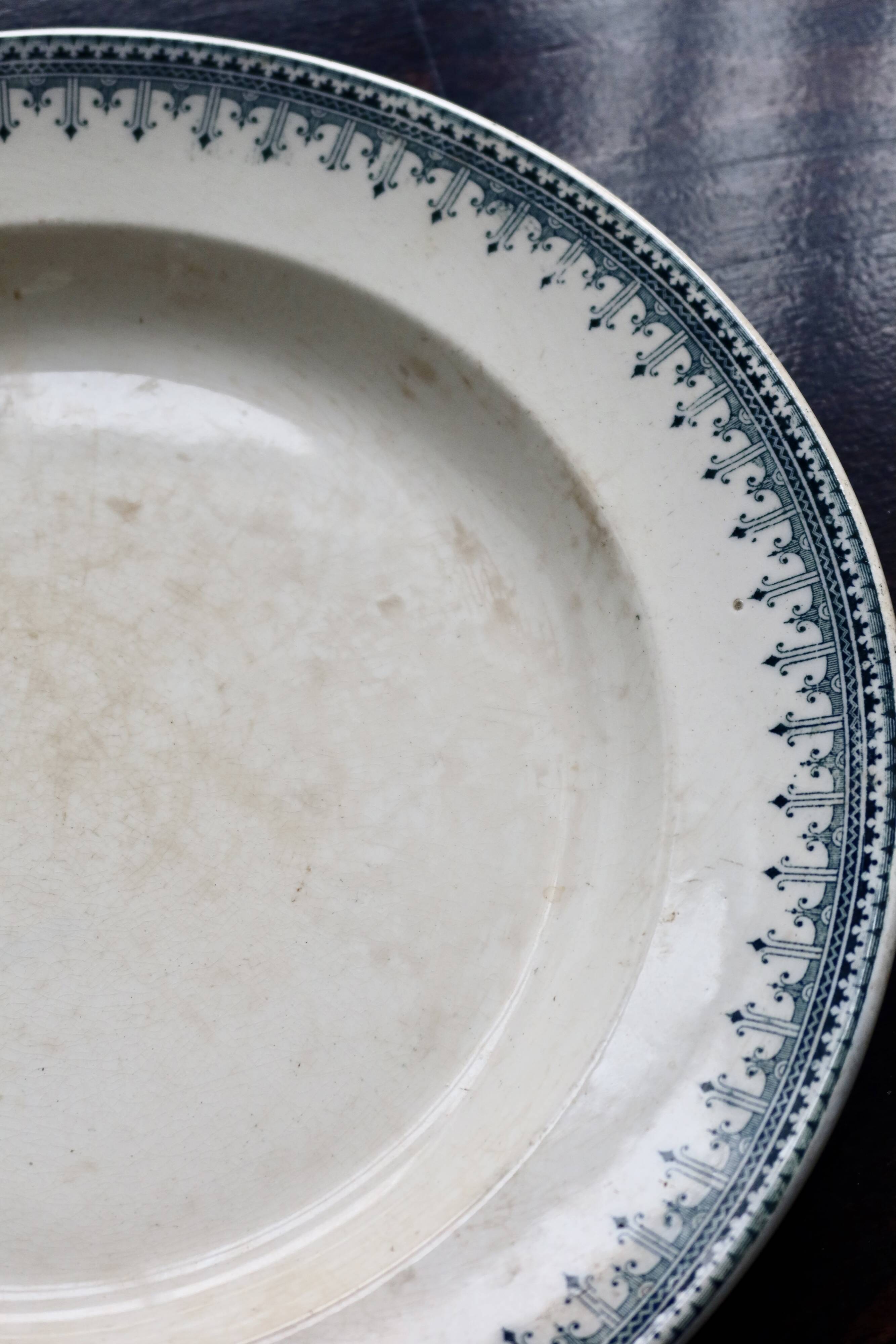 Round vintage patinated ironstone serving dish - Border model