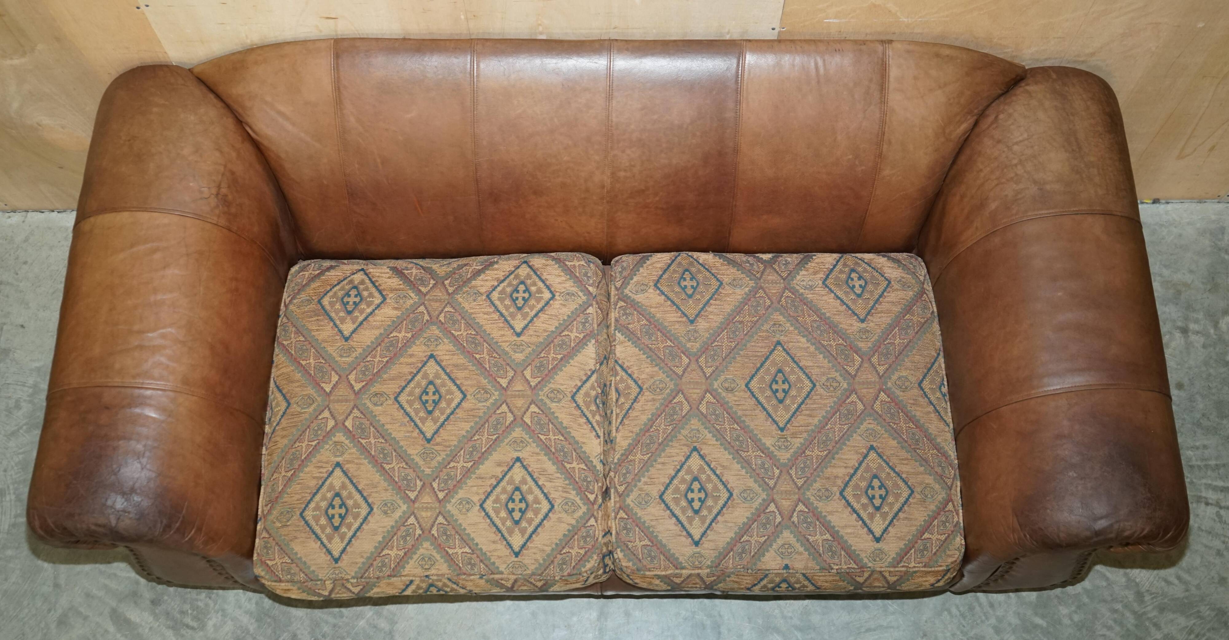 Vintage leather sofas by Thomas Lloyd with Kilim cushions.