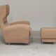 Beige wingback armchair and TVAR footrest, former Czechoslovakia.