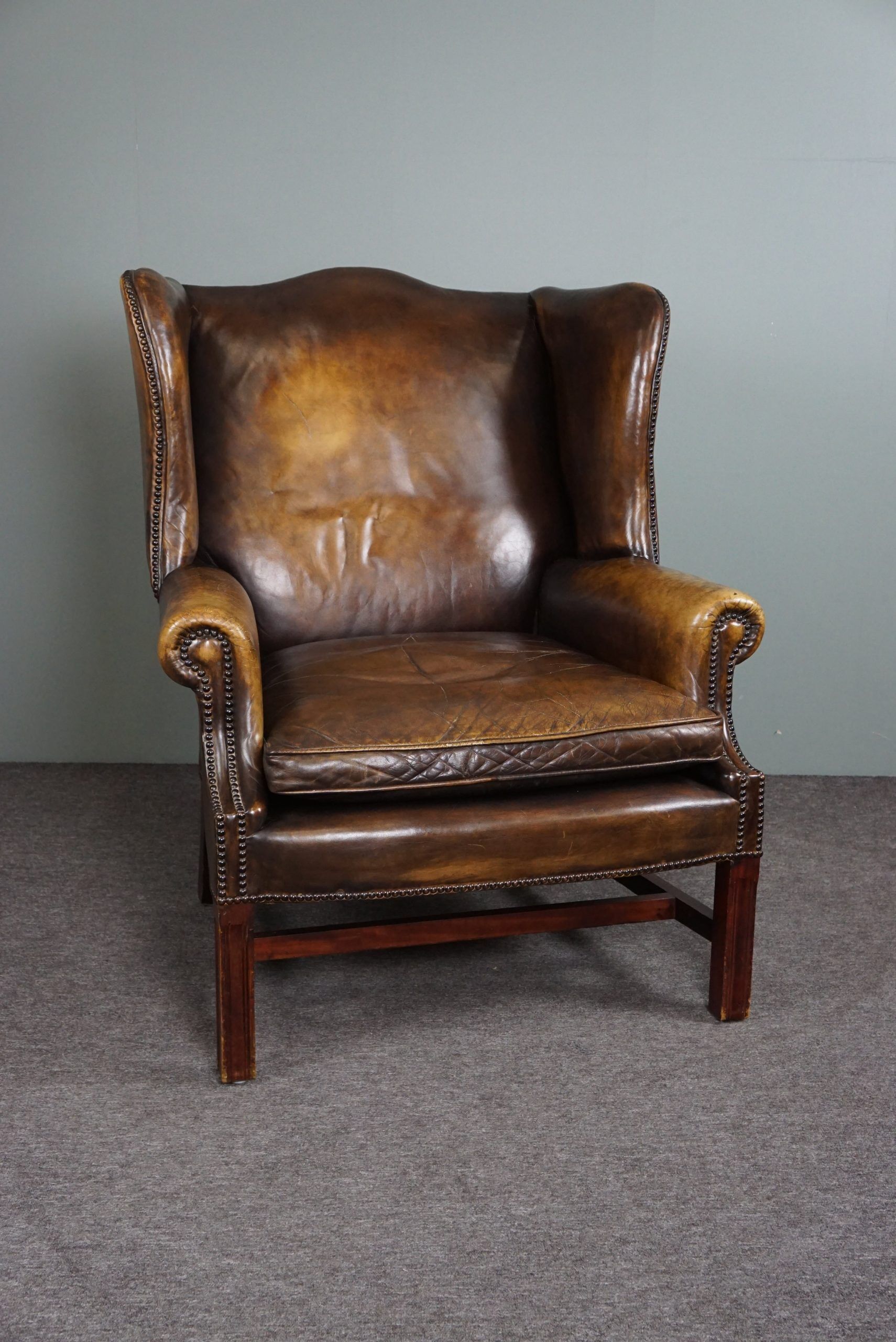 Patinated cowhide leather armchair