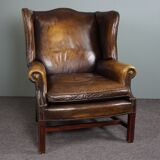 Patinated cowhide leather armchair