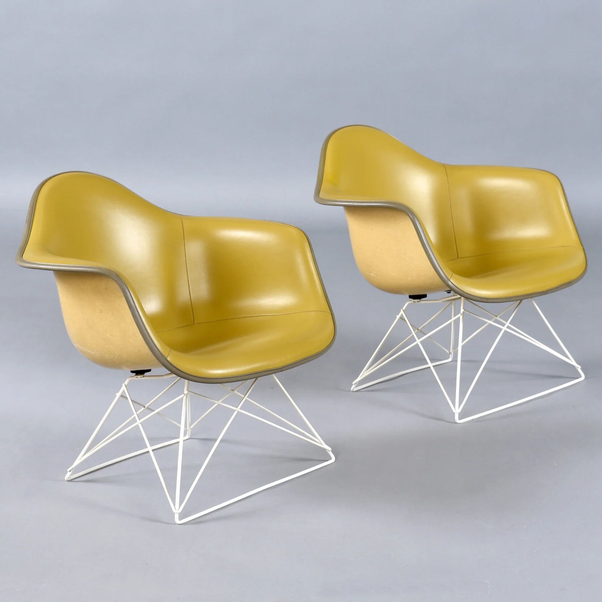 Paire de chaises coque LAR Eames pour Herman Miller avec des coussins en Naugahyde jaune.