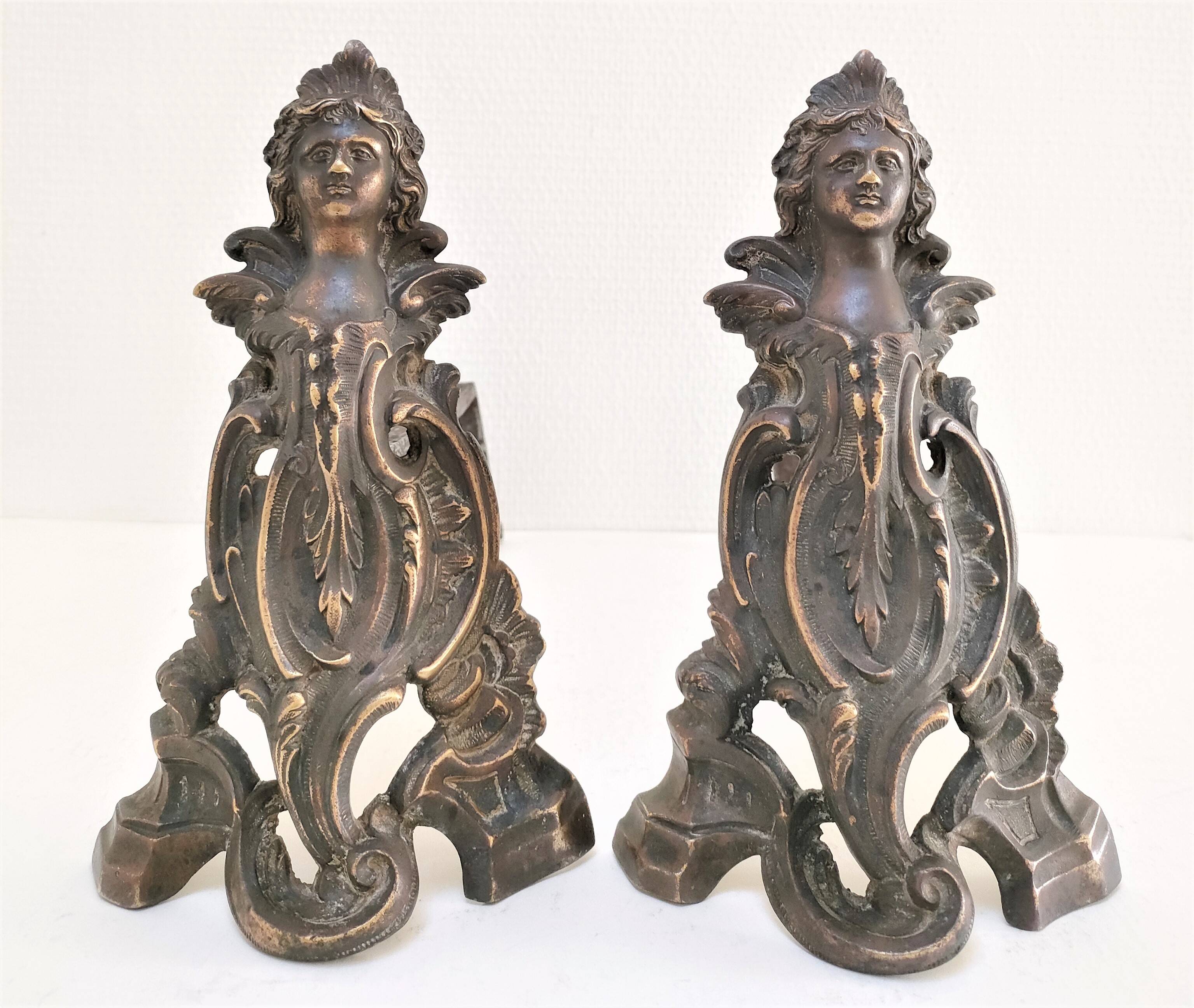 Pair of bronze andirons with black patina, 19th century, female caryatids