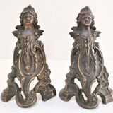 Pair of bronze andirons with black patina, 19th century, female caryatids