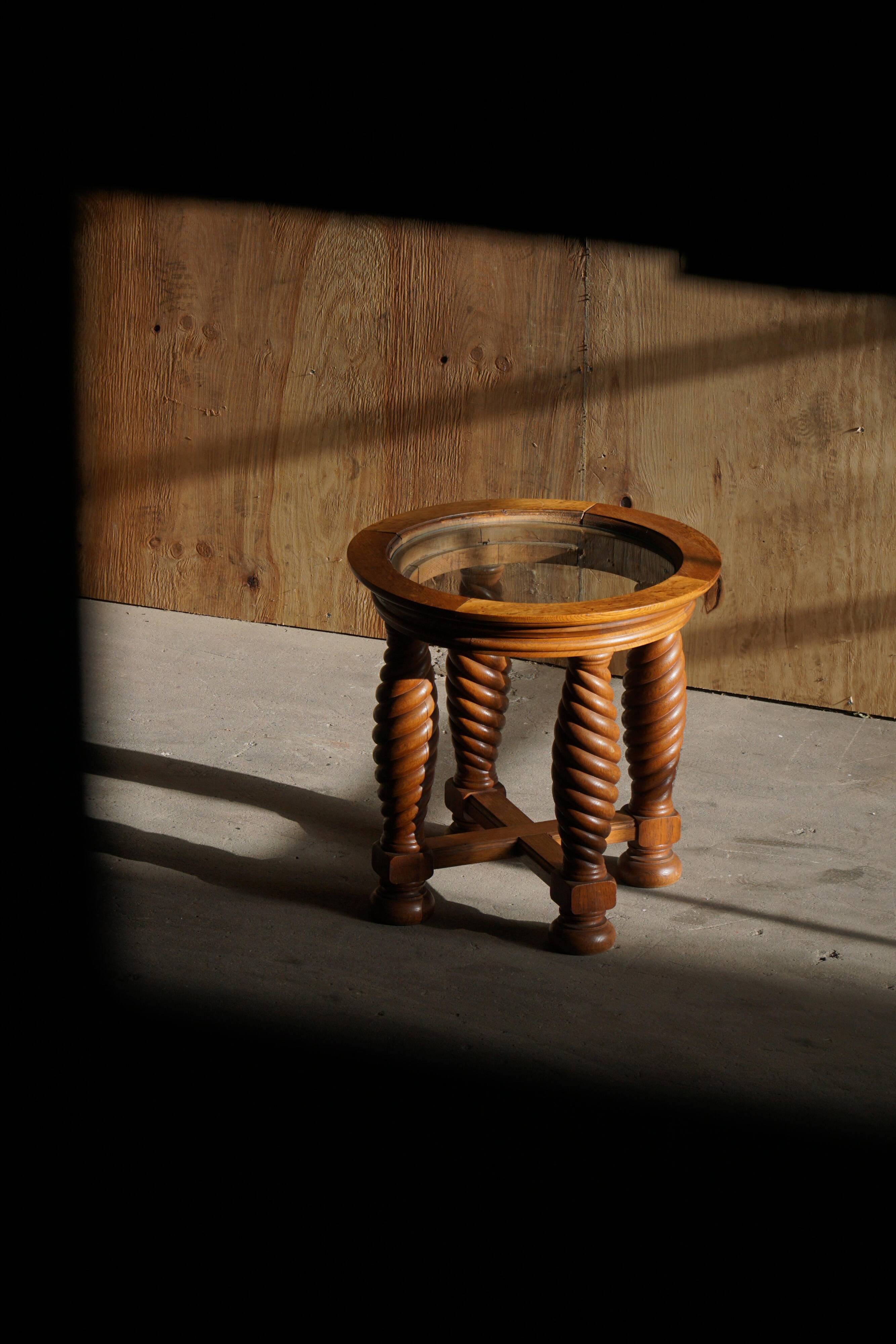 Modern Danish mid-century table, made of oak with spiral turned legs and a glass top, 1950s.
