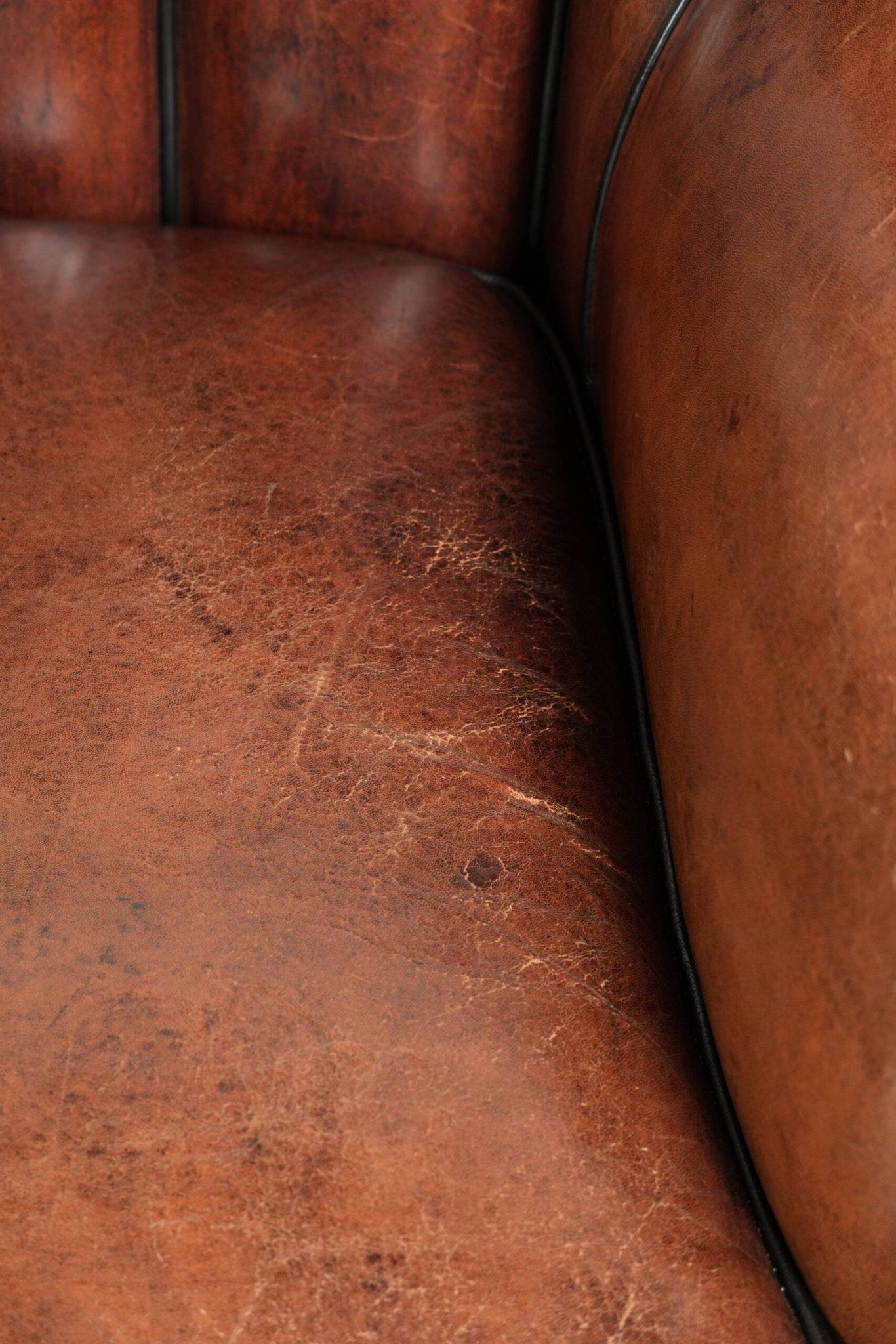 Unique sheepskin armchair with warm deep colours finished with black piping