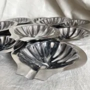 Set of 12 stainless steel scallop shells, 1970s-80s.