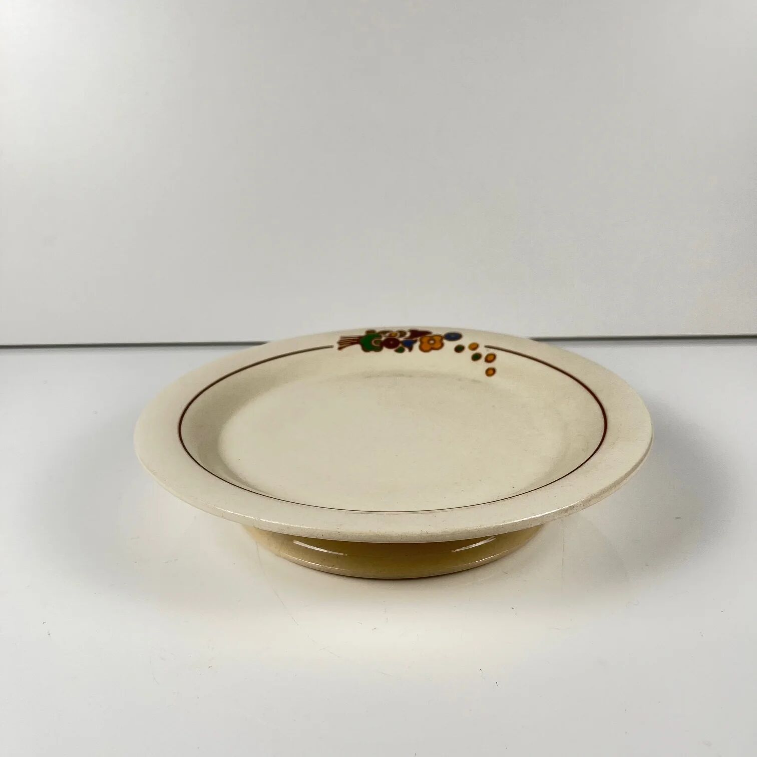 Presentation plate with pedestal Longwy, early 20th century, floral decoration.