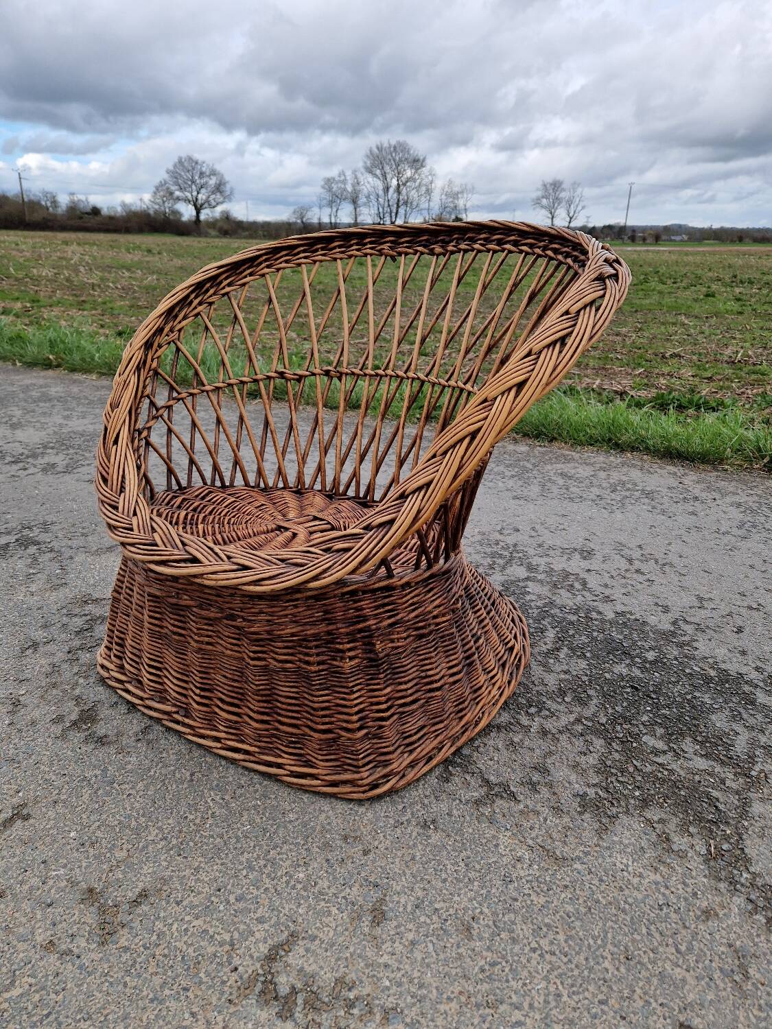 Old throne basket armchair in woven wicker