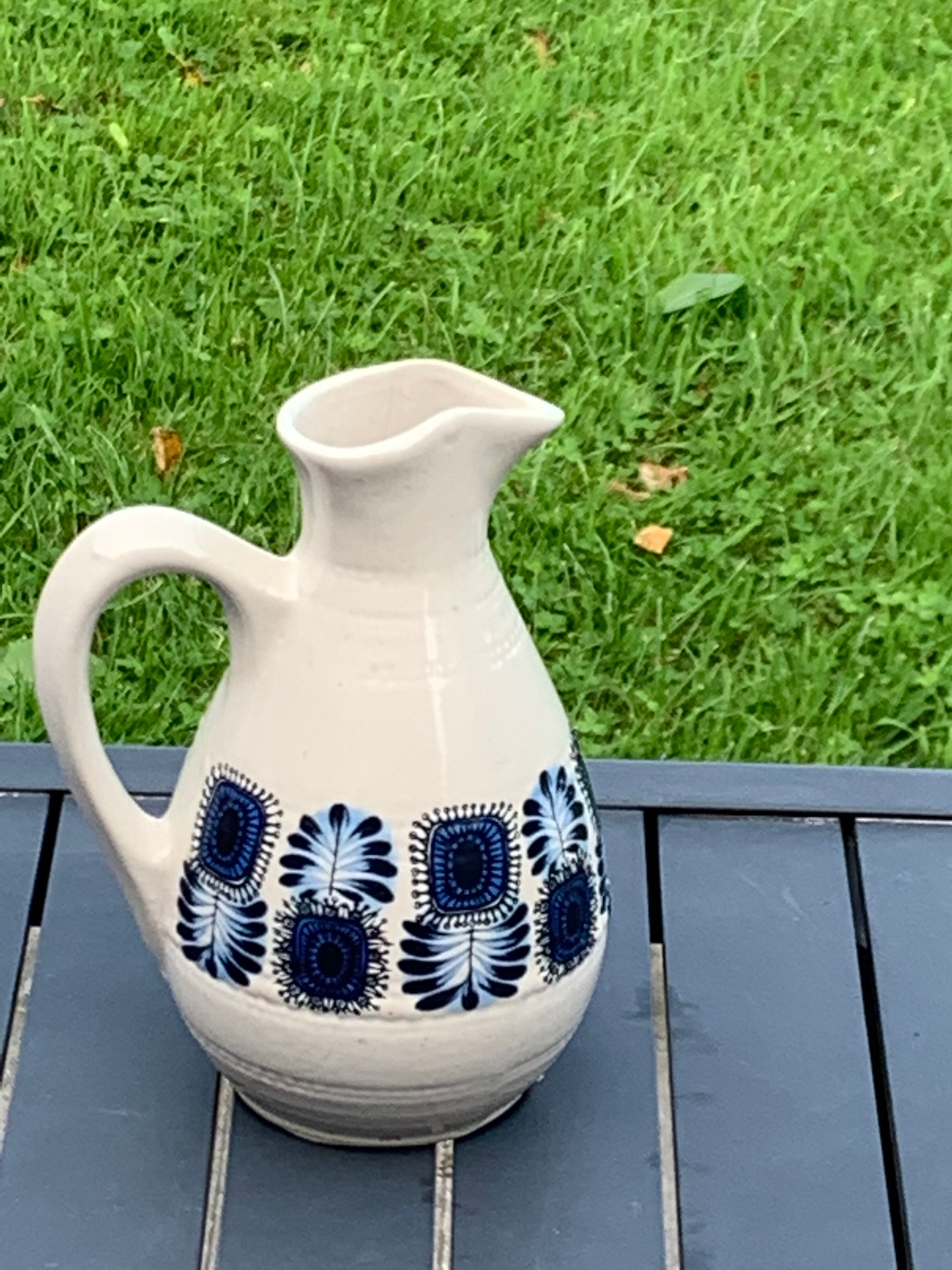 Enamelled sandstone carafe with a nice pattern of vintage blue flowers and 1970 design