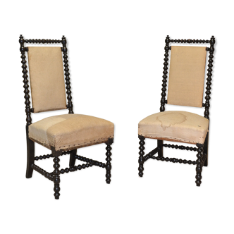 Pair of low armchairs in blackened wood