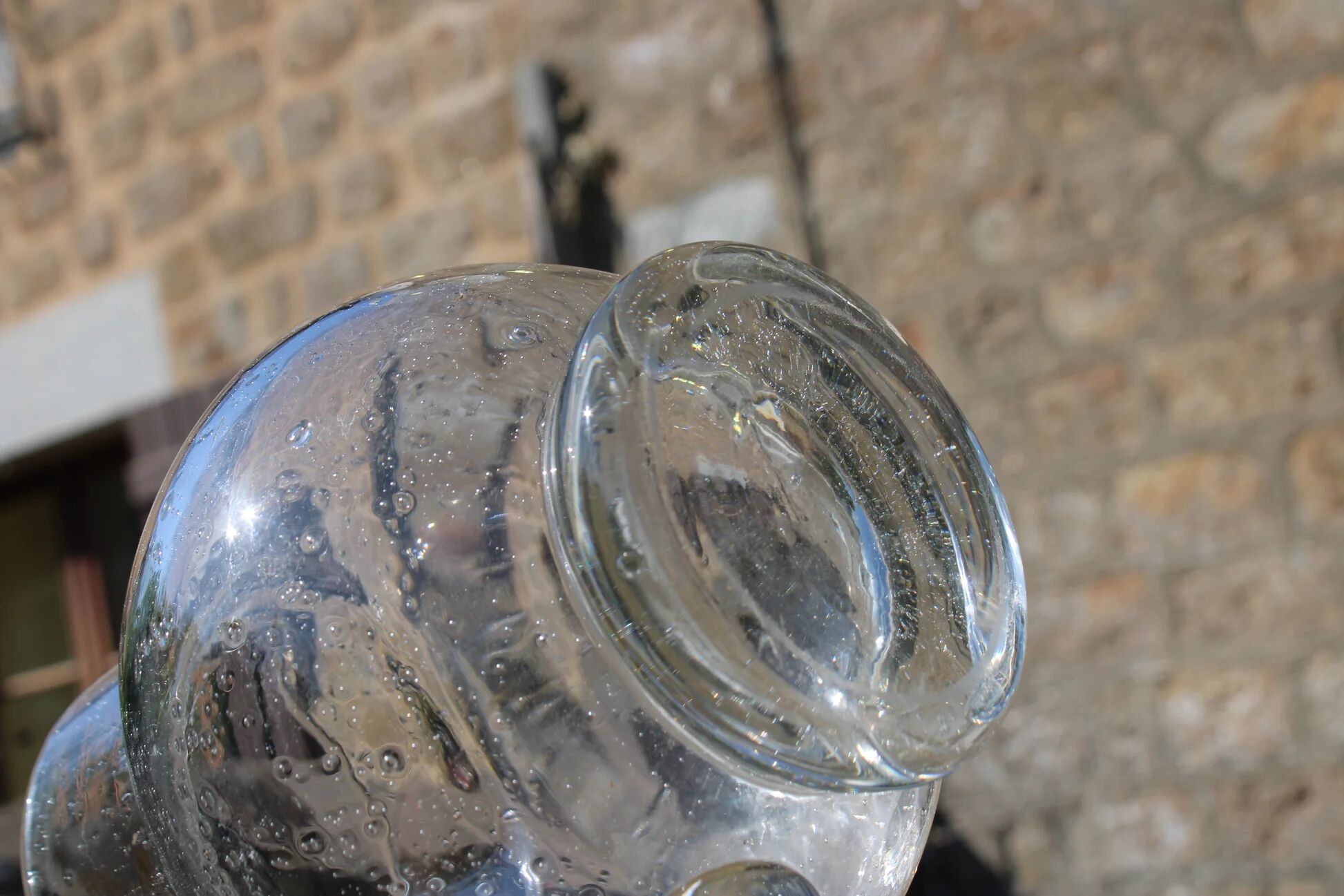 Vintage blown glass pitcher with bubbles, transparent.
