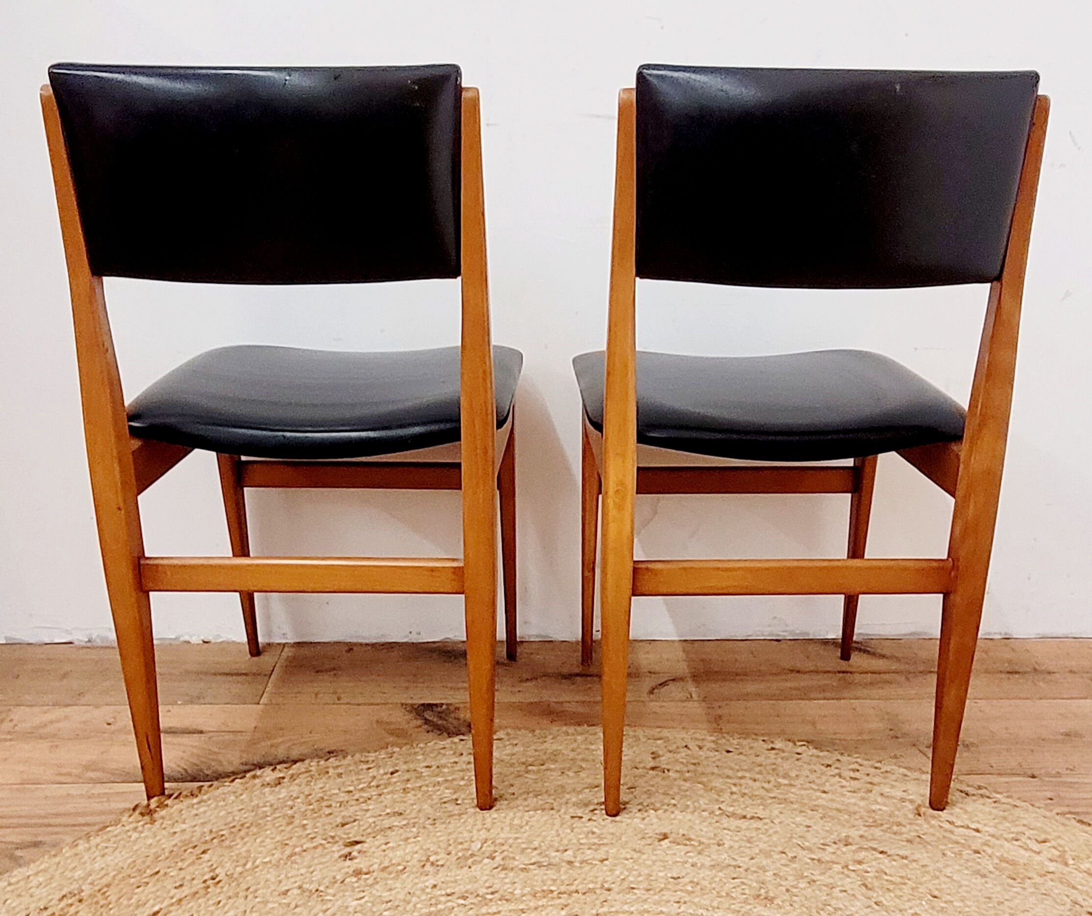 Six vintage wooden chairs and black Skaï