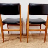 Six vintage wooden chairs and black Skaï