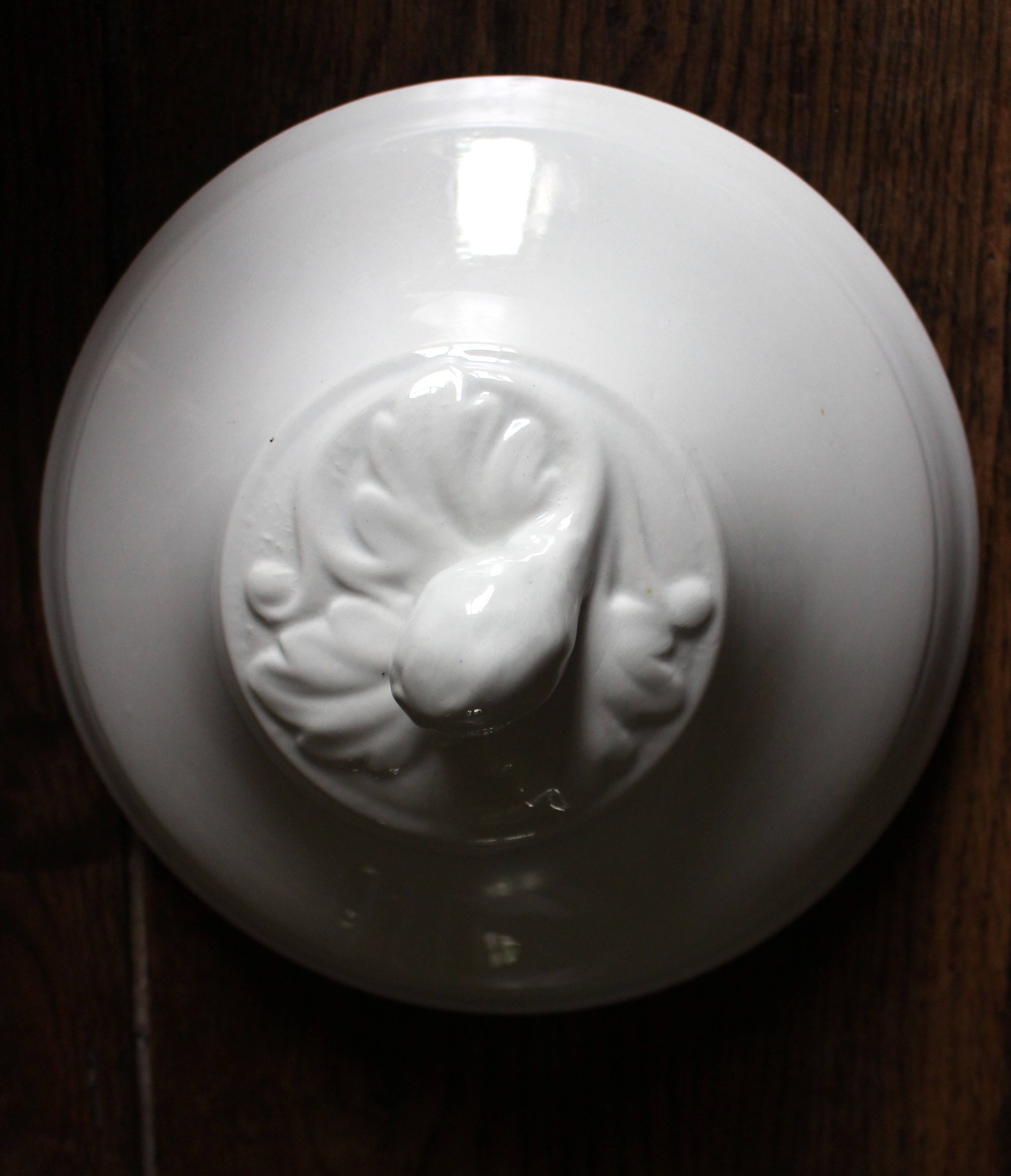 Antique soup tureen, white earthenware, with stopper decoration.
