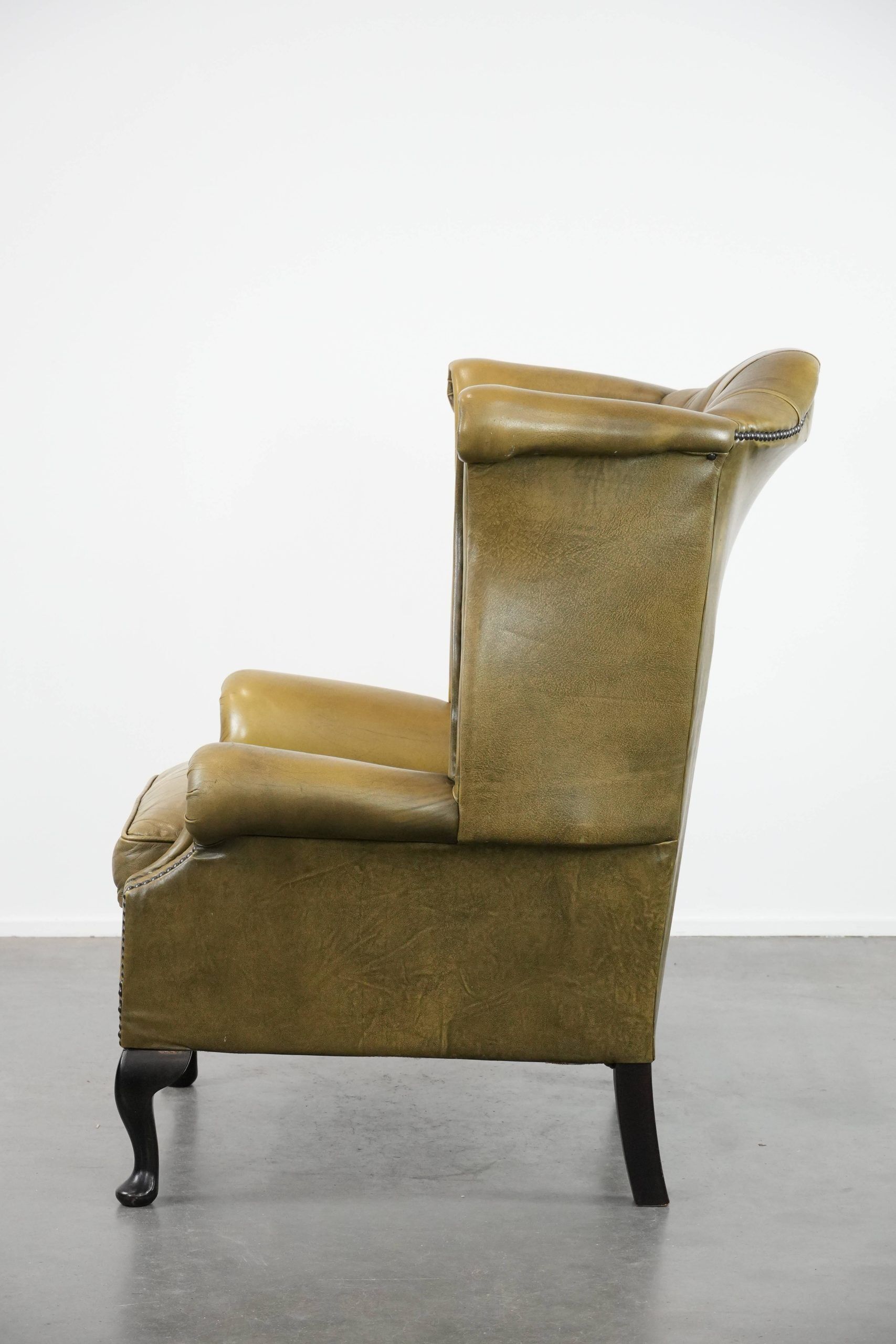 Moss green cow leather Chesterfield wingback armchair in English style