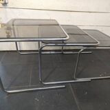 Nesting tables in chromed metal with smoked glass tops from the 1970s