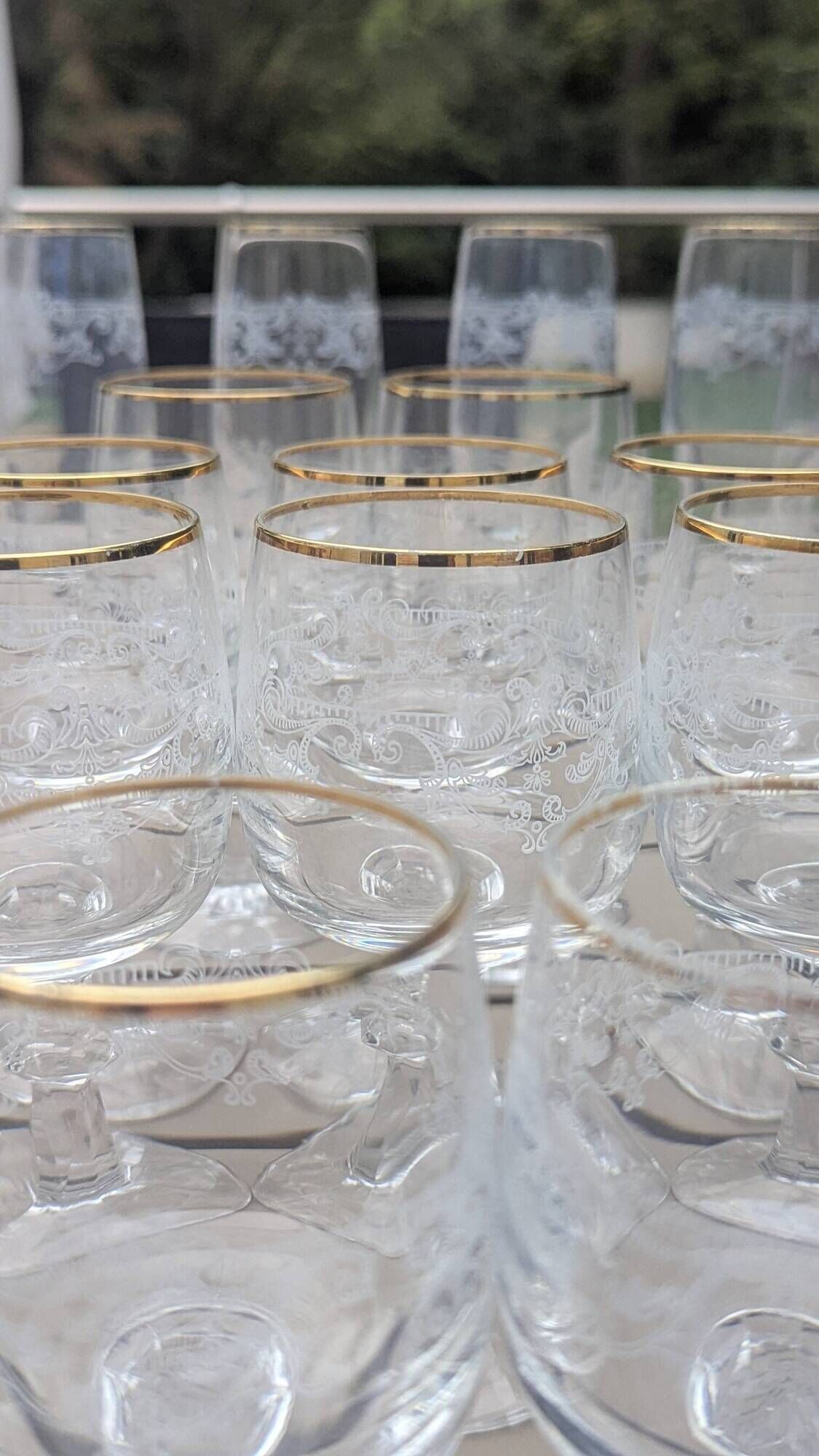 Set of 15 engraved crystal glasses with a gold rim.