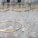 Set of 15 engraved crystal glasses with a gold rim.