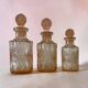Set of 3 vintage pink glass bottles with corks.