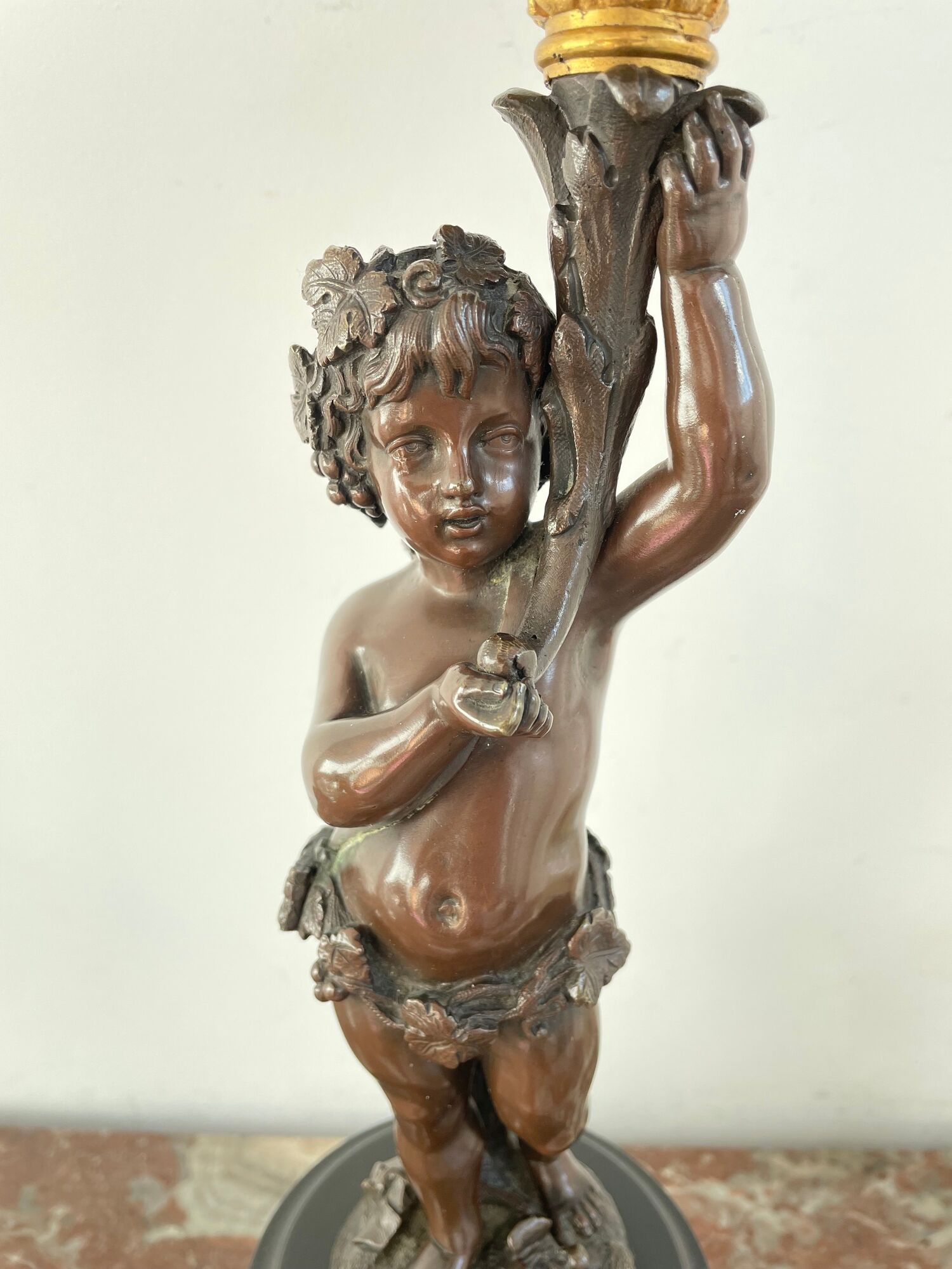 Candelabra with cherub in patinated bronze