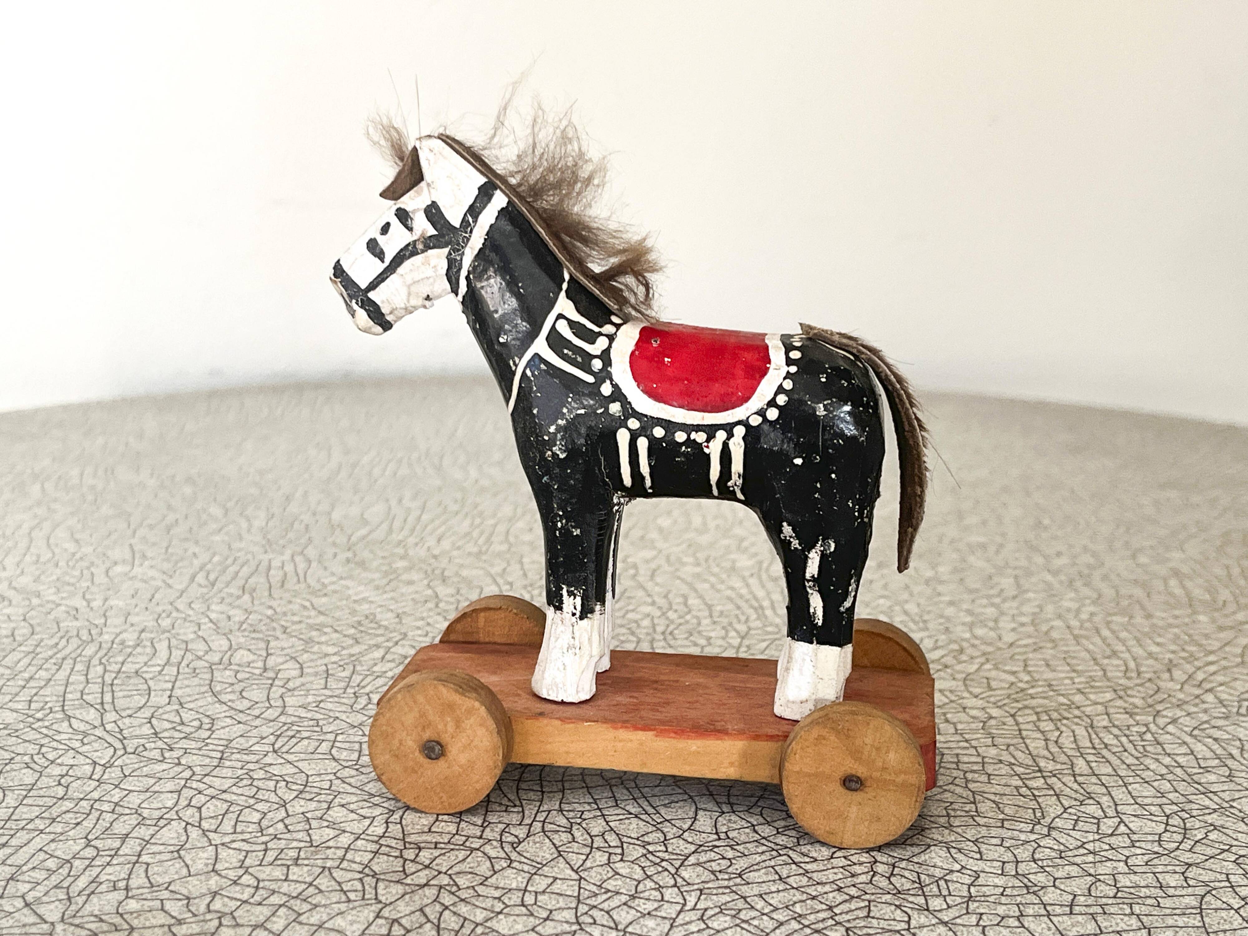 Old wooden pull-along toy, horse.