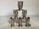 Six silver-plated metal candlesticks with punches