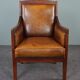 Armchair in sheepskin with wood
