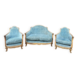 Art deco living room around 1920 in carved wood upholstered in blue velvet, a sofa two armchairs