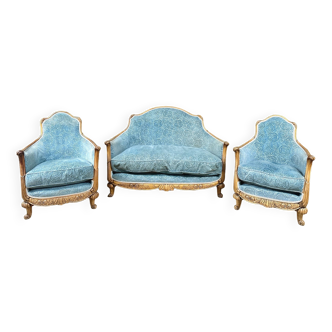 Art deco living room around 1920 in carved wood upholstered in blue velvet, a sofa two armchairs