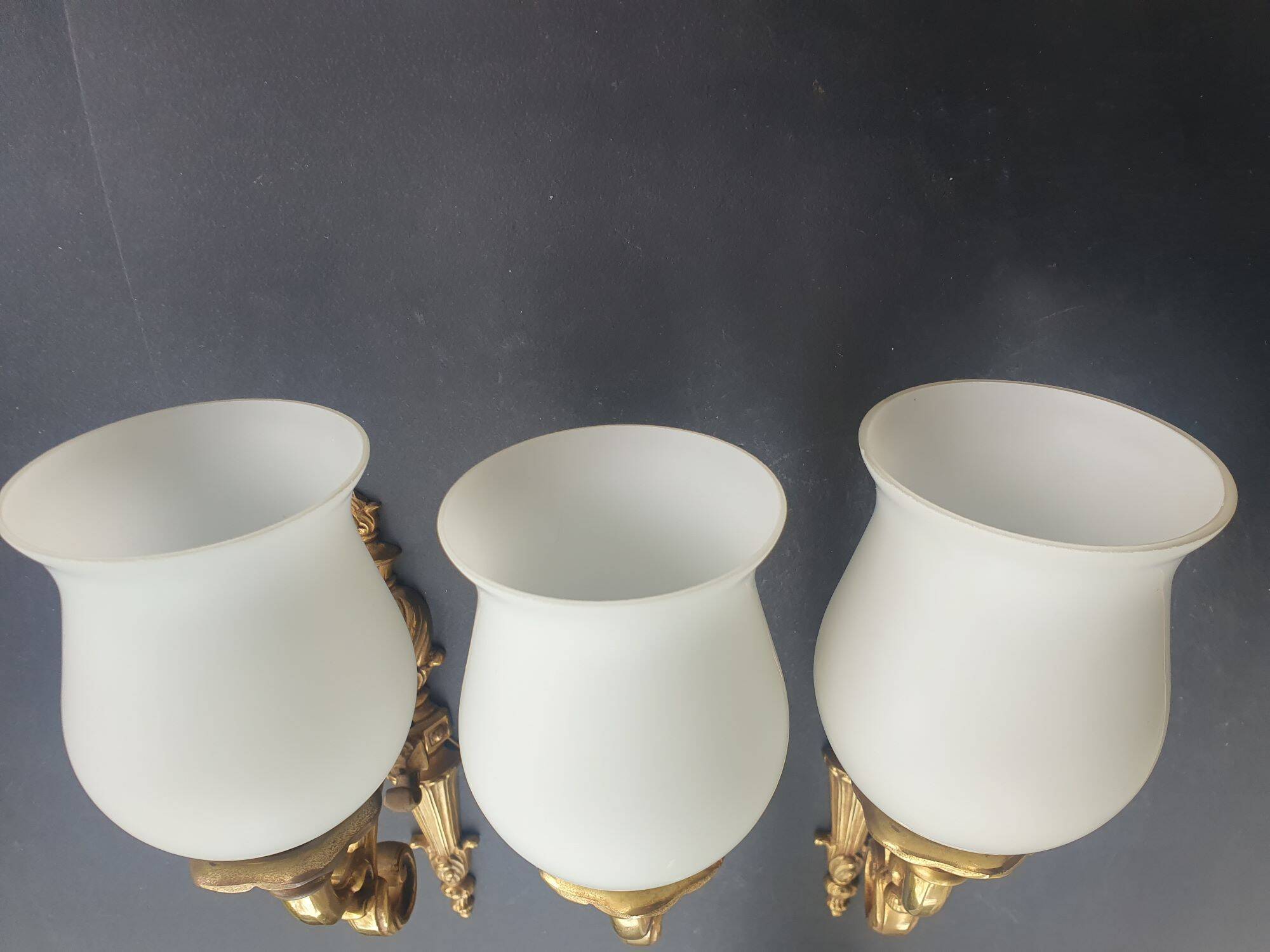 Three large vintage torch wall sconces.
