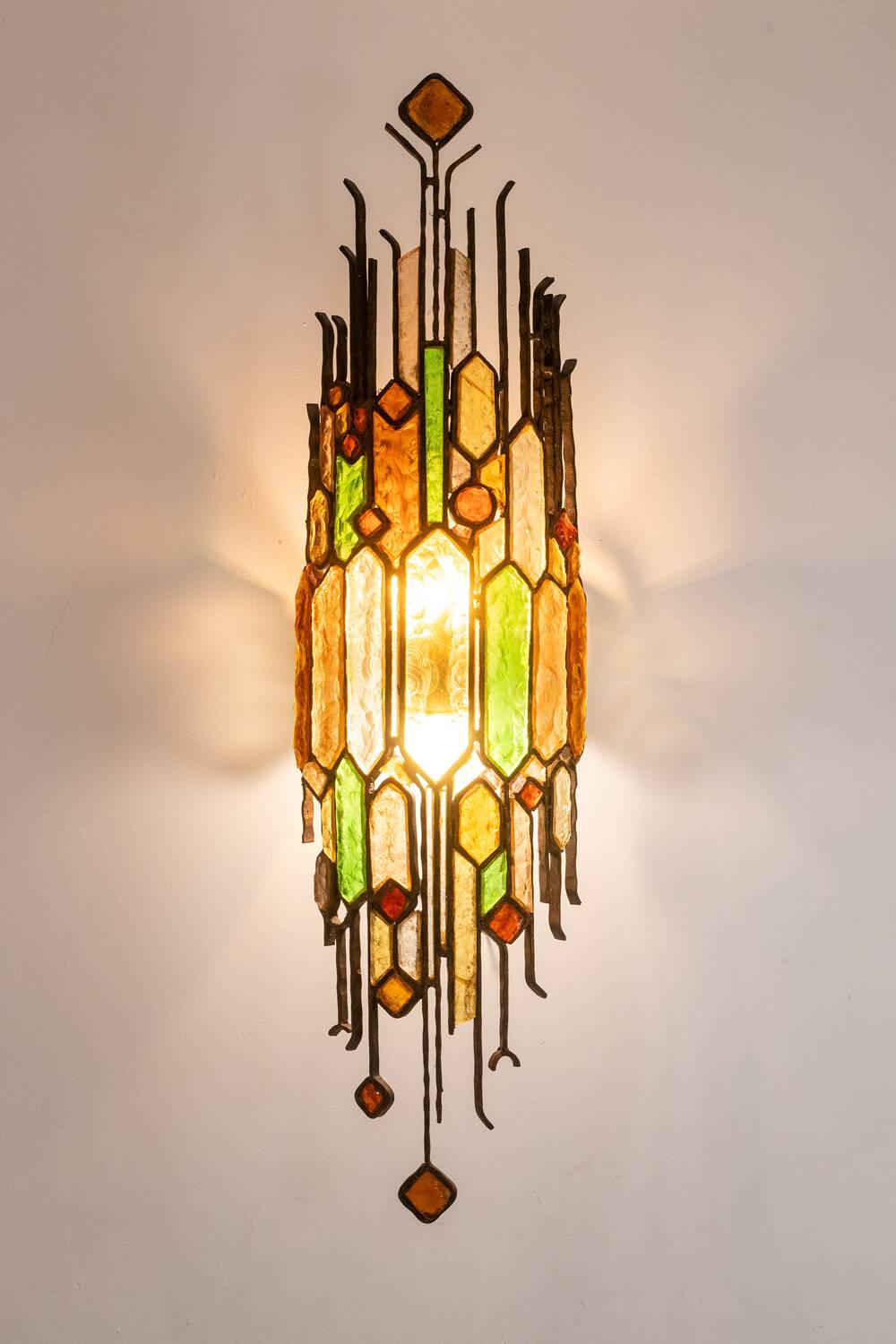 Wrought iron and colored glass wall light. 1960s.