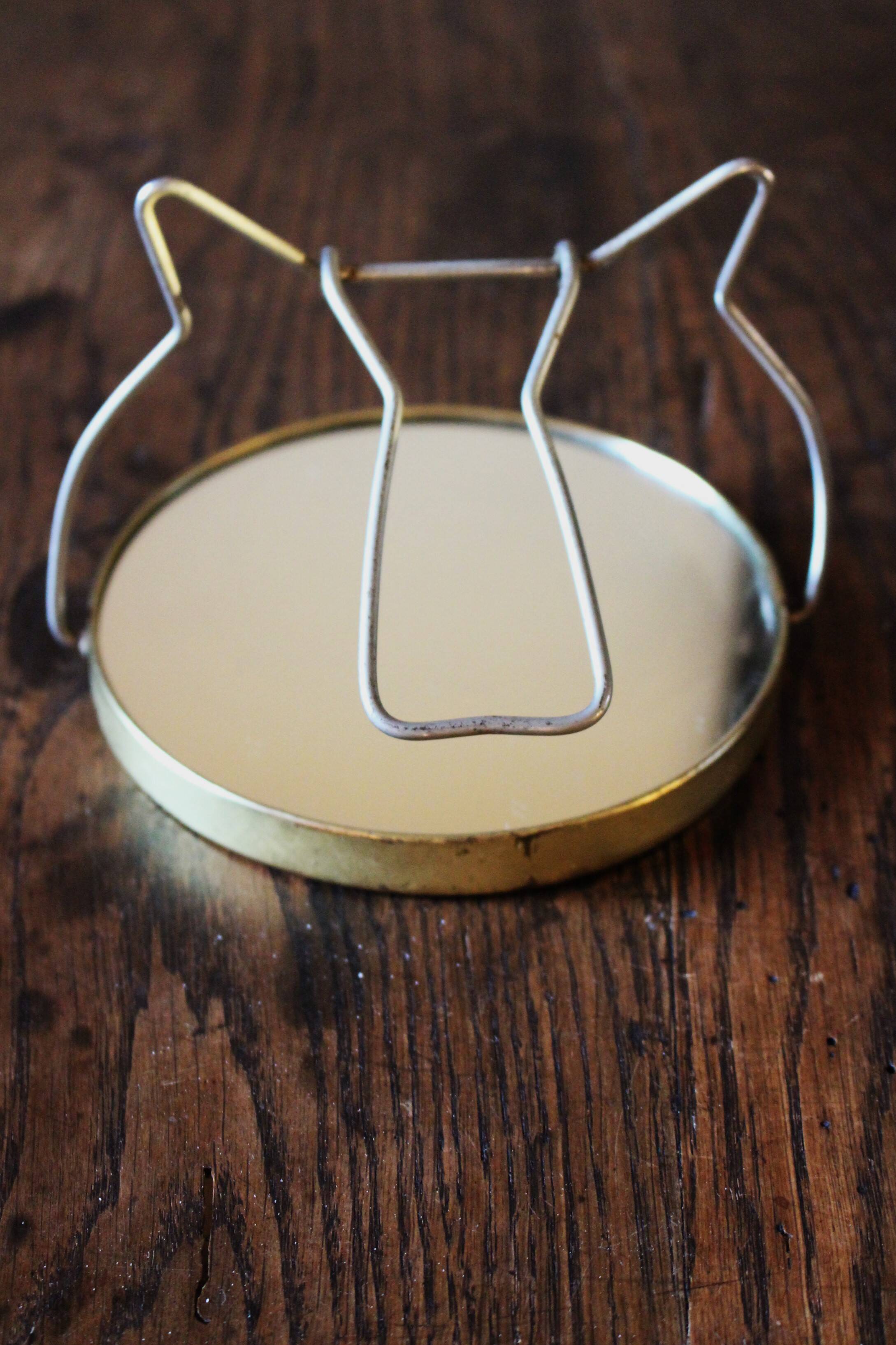 Antique round barber mirror in gilded metal
