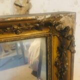 Old mirror with gilded leaves and flowers carved on top of it 1800s