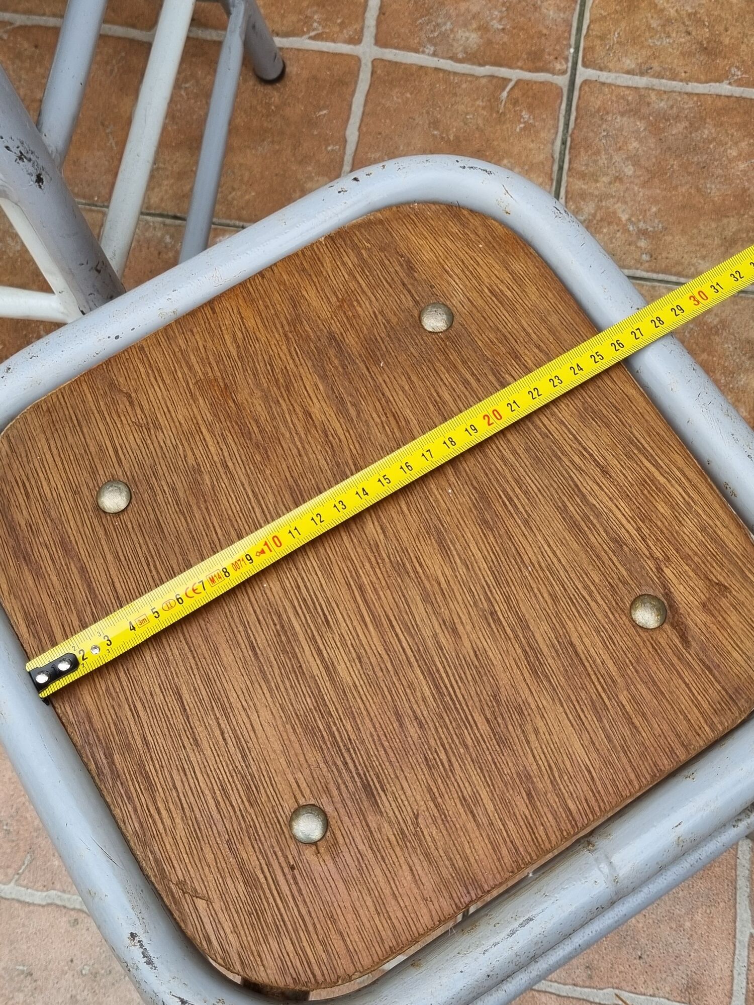 Set of four stackable industrial tubular metal and wood stools