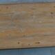 Industrial style coffee table with wooden top supported by a metal base -