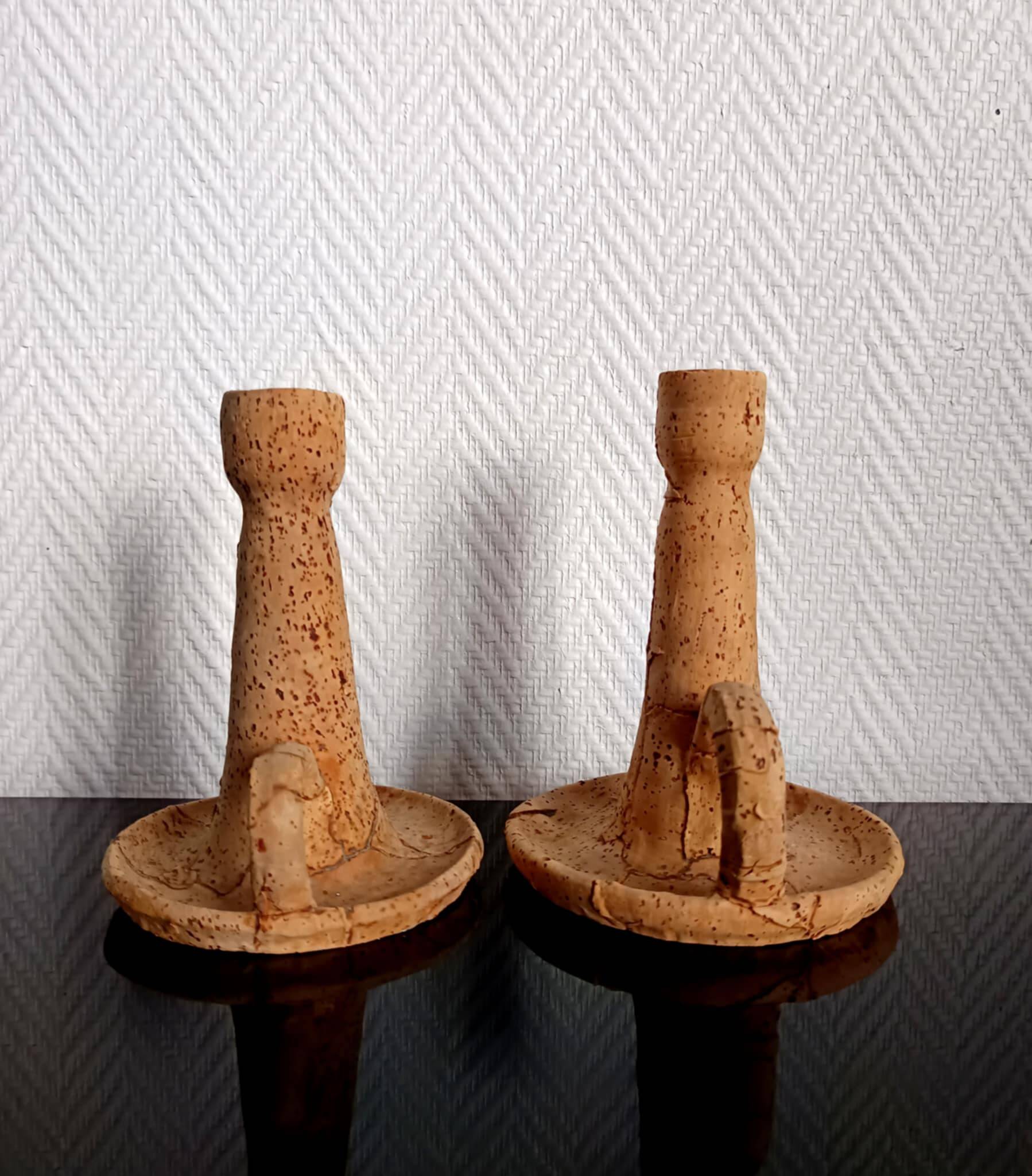 Pair of cork and terracotta candlesticks.