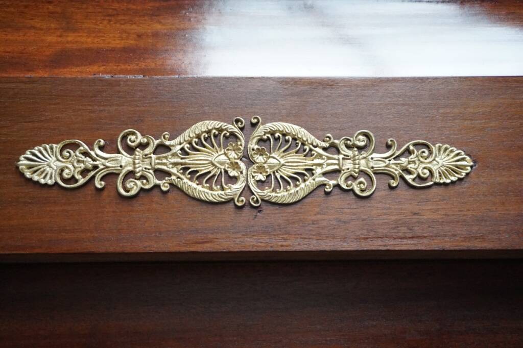 Empire style mahogany display bookcase with gilt bronze decoration and three doors.