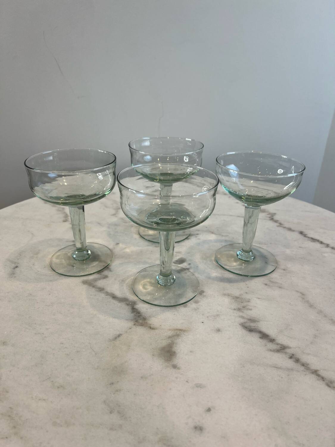 Set of four blown glass stemmed glasses.
