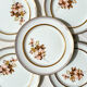 8 Petites assiettes en porcelaine OLYMPIA motif fleuris et dorure