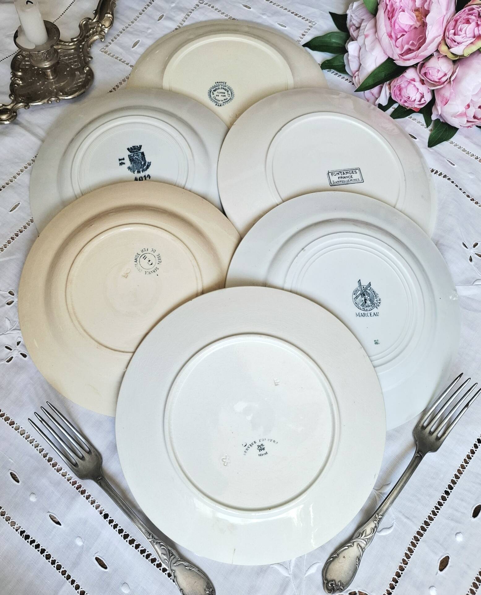 Old mismatched flat plates made of ironstone earthenware.
