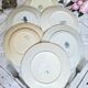 Old mismatched flat plates made of ironstone earthenware.