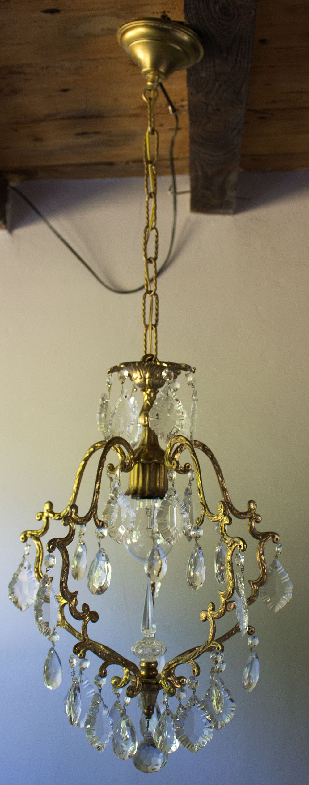 Old brass chandelier with glass stamps