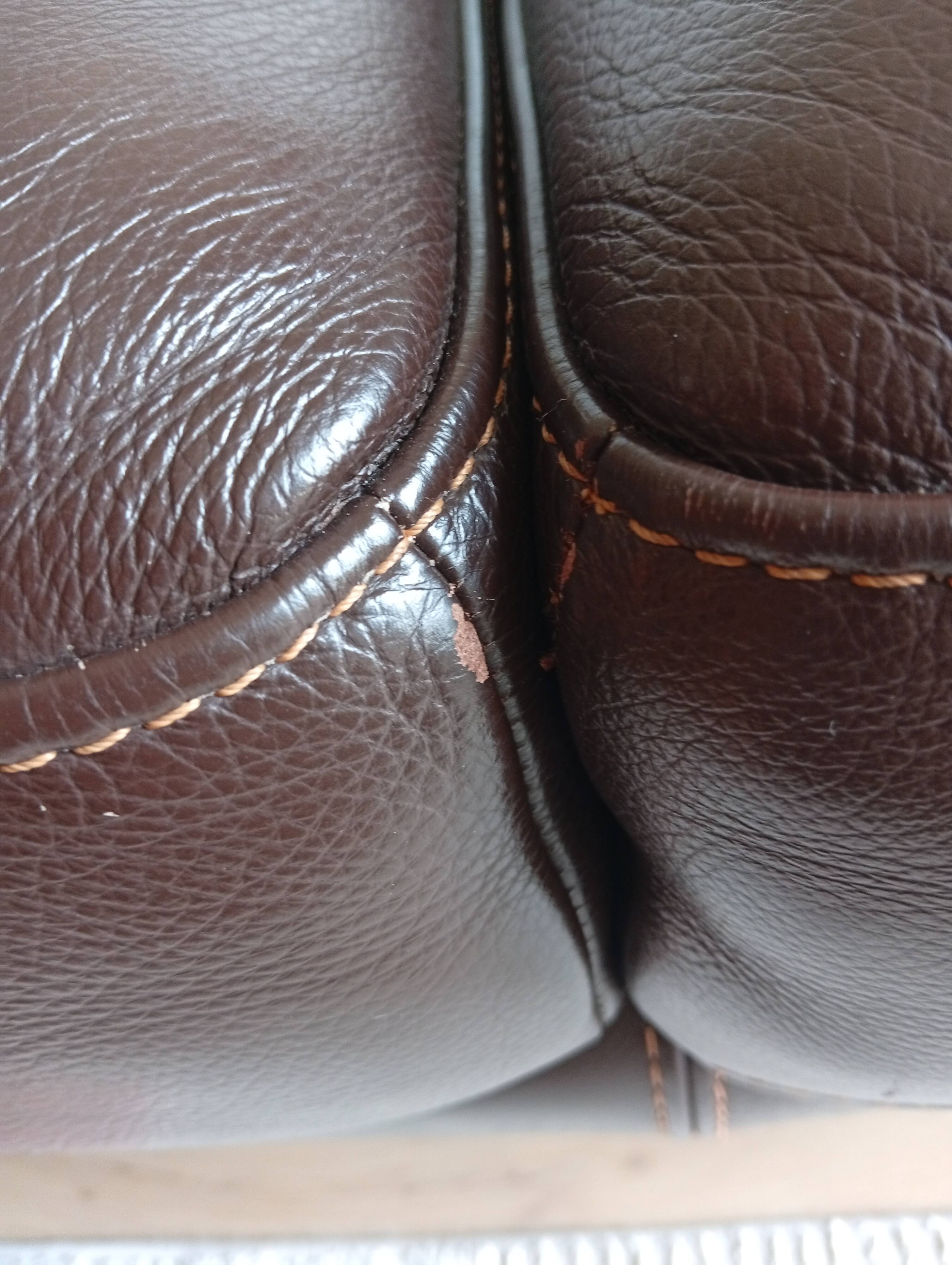 Two brown leather Crozatier two-and-a-half-seater sofas.