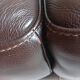 Two brown leather Crozatier two-and-a-half-seater sofas.